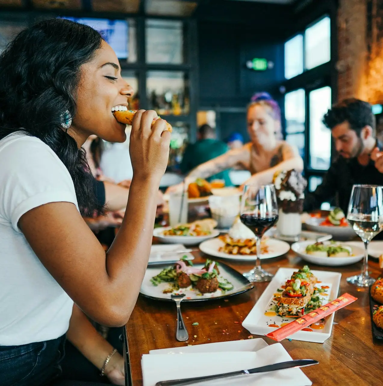 woman in white shirt eating